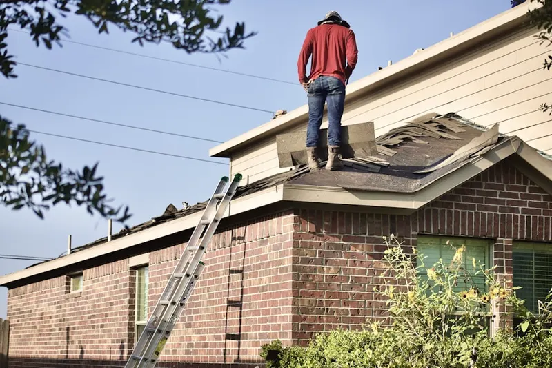 Professional roofer working on a residential roof in Hacienda Village